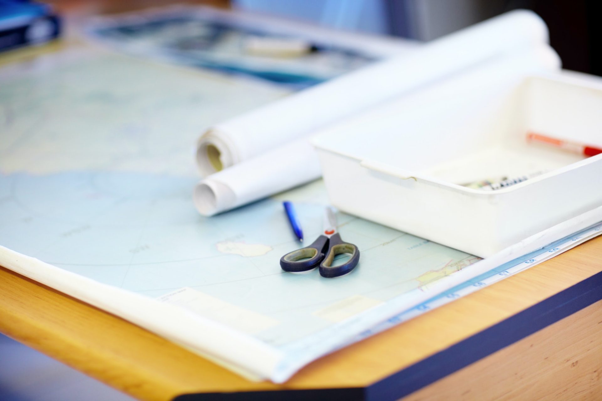High angle shot of a map and stationary lying on a desk inside a lifeguard office